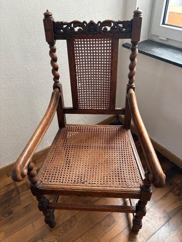 Antieke stoel met rieten zit en rug
