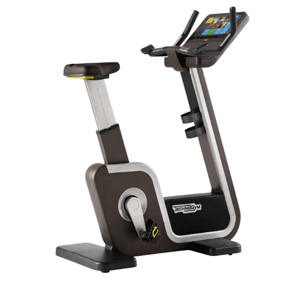 Tecnogym - Bike Artis Unity 3.0 - Upright Bike - Bruin, Ophalen of Verzenden, Zo goed als nieuw, Benen, Overige typen