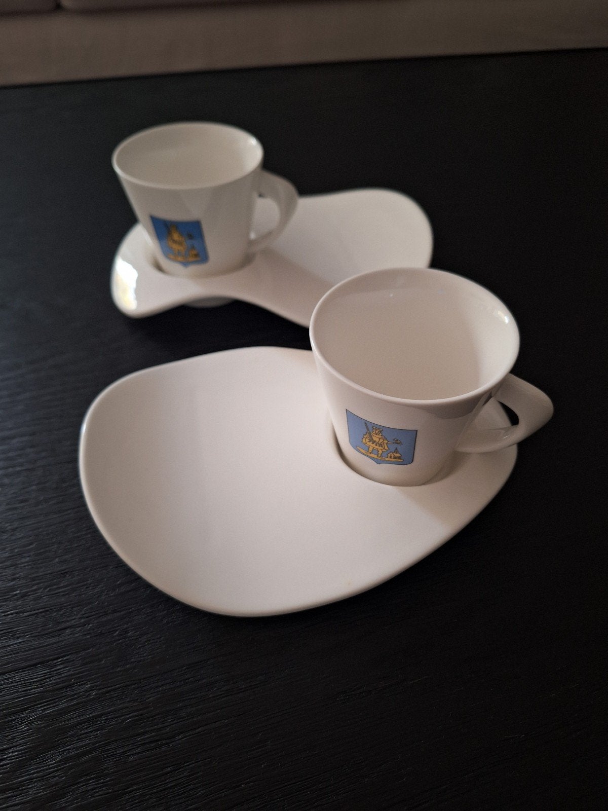 2 tassen met bordjes met het embleem van Wilrijk, Ophalen
