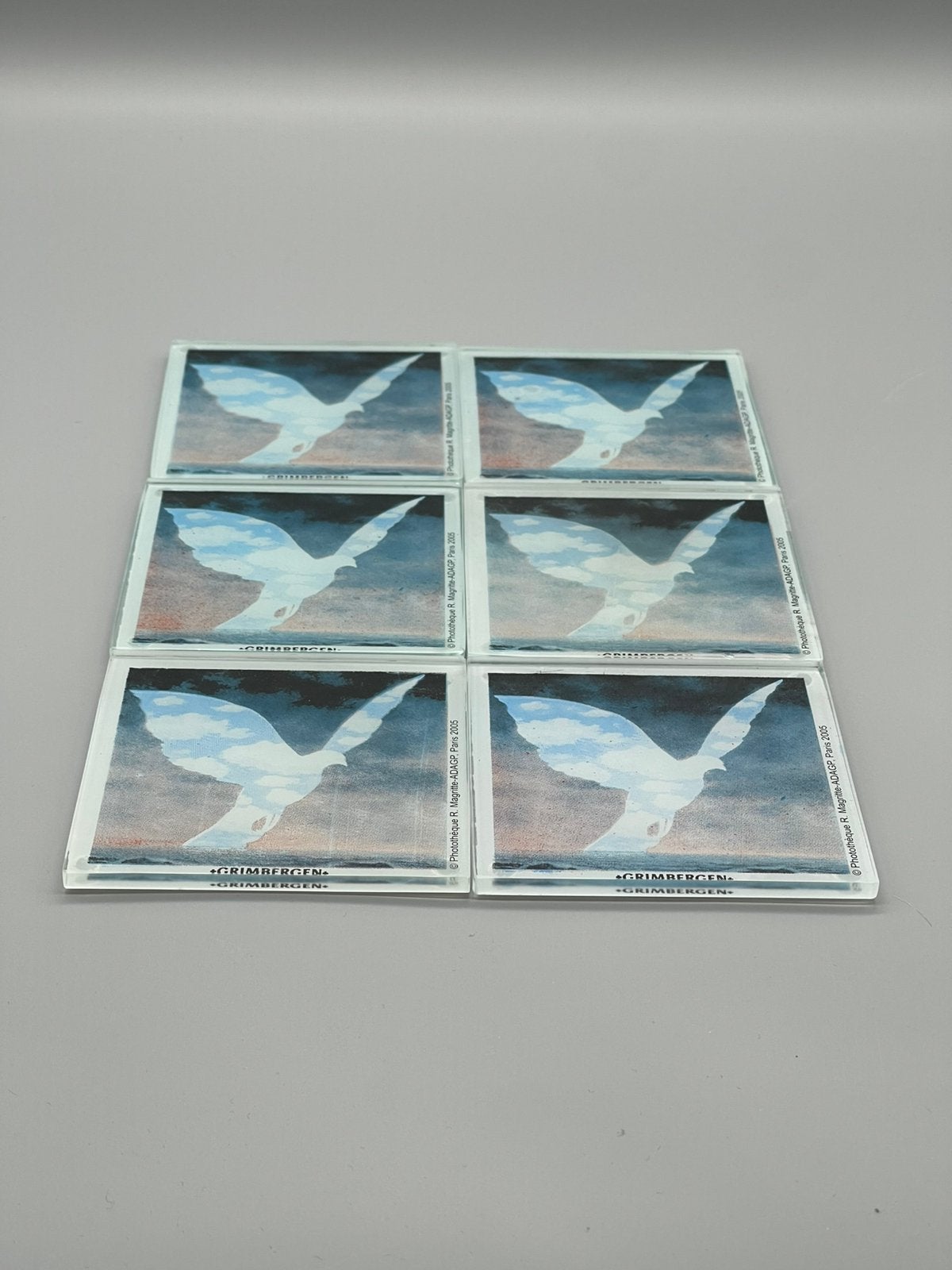 6 glazen onderzetter Grimbergen – René Magritte (2005), Glasonderzetter, Stapelbaar, Ophalen of Verzenden, Zo goed als nieuw
