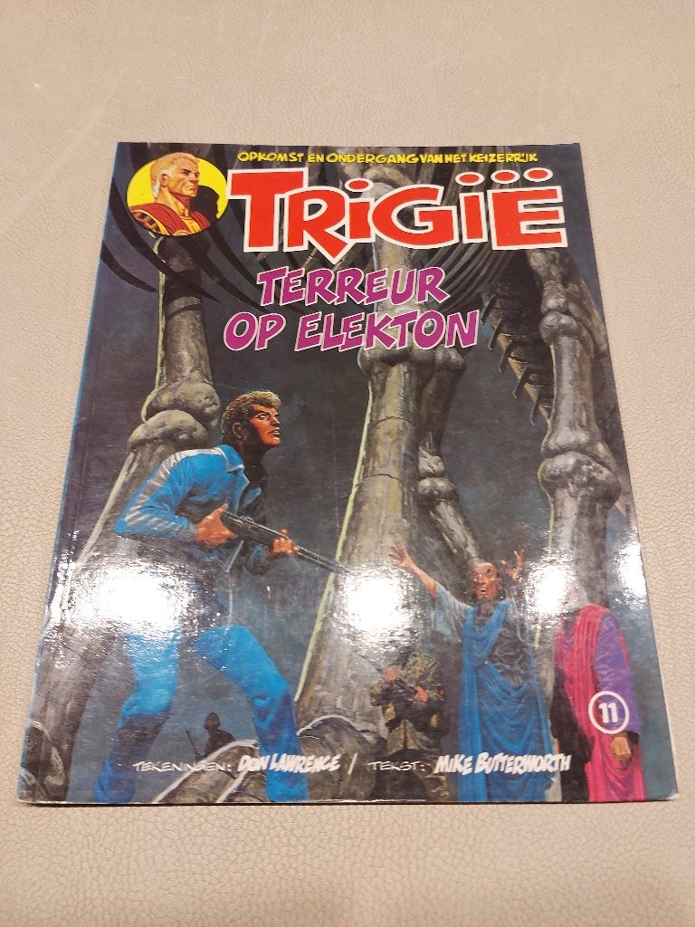 Trigië 11 : Terreur op Elekton, Boeken, Gelezen, Eén stripboek, Ophalen of Verzenden, Don Lawrence