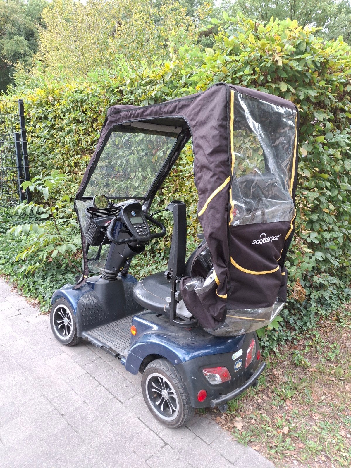 Compleet dichte kap voor een scootmobiel, Ophalen
