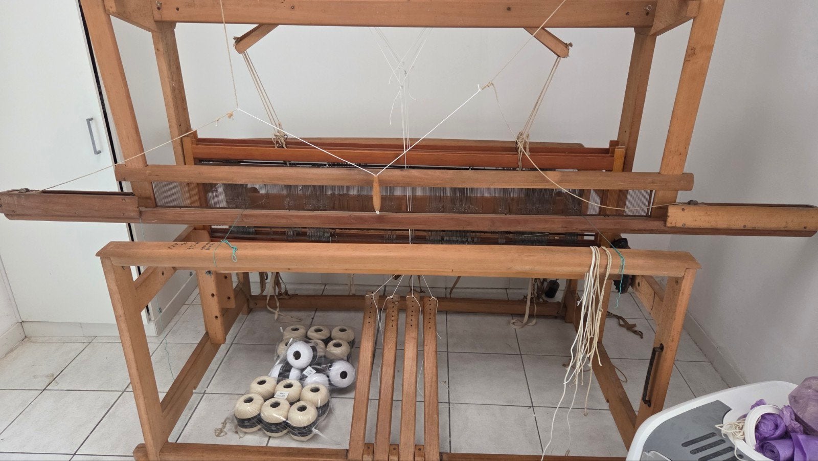 professioneel handweefgetouw met schietspoel, Ophalen