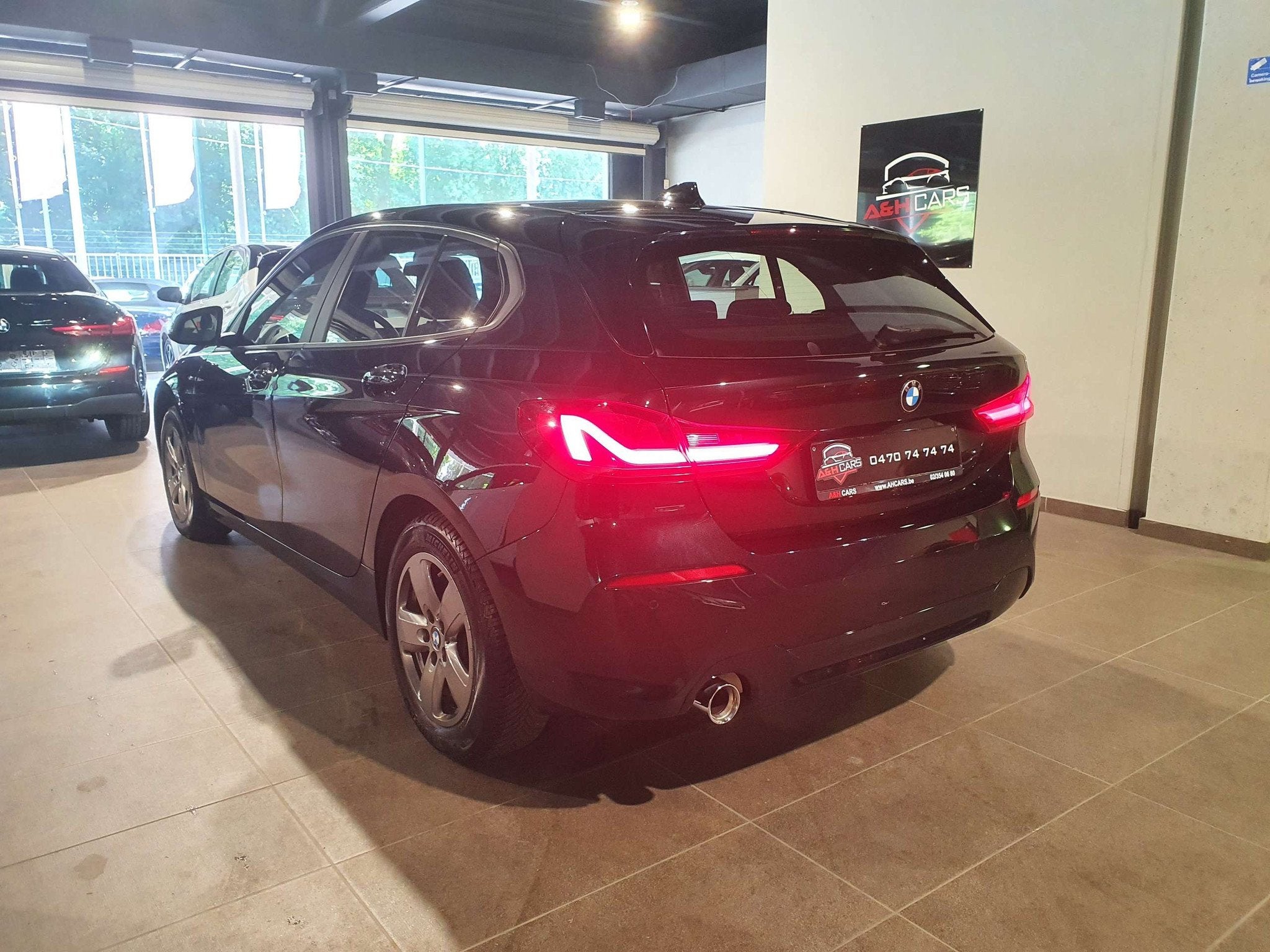 BMW 1 Serie 118 118iA OPF (bj 2019, automaat), Auto's, Gebruikt, Zwart, Bedrijf, 5 deurs