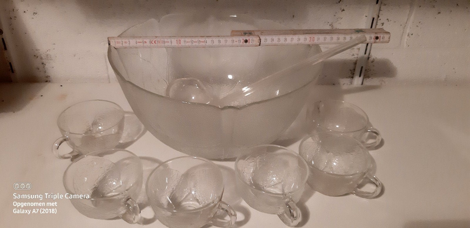 Glazen kom met 6 kopjes voor punsch, Ophalen