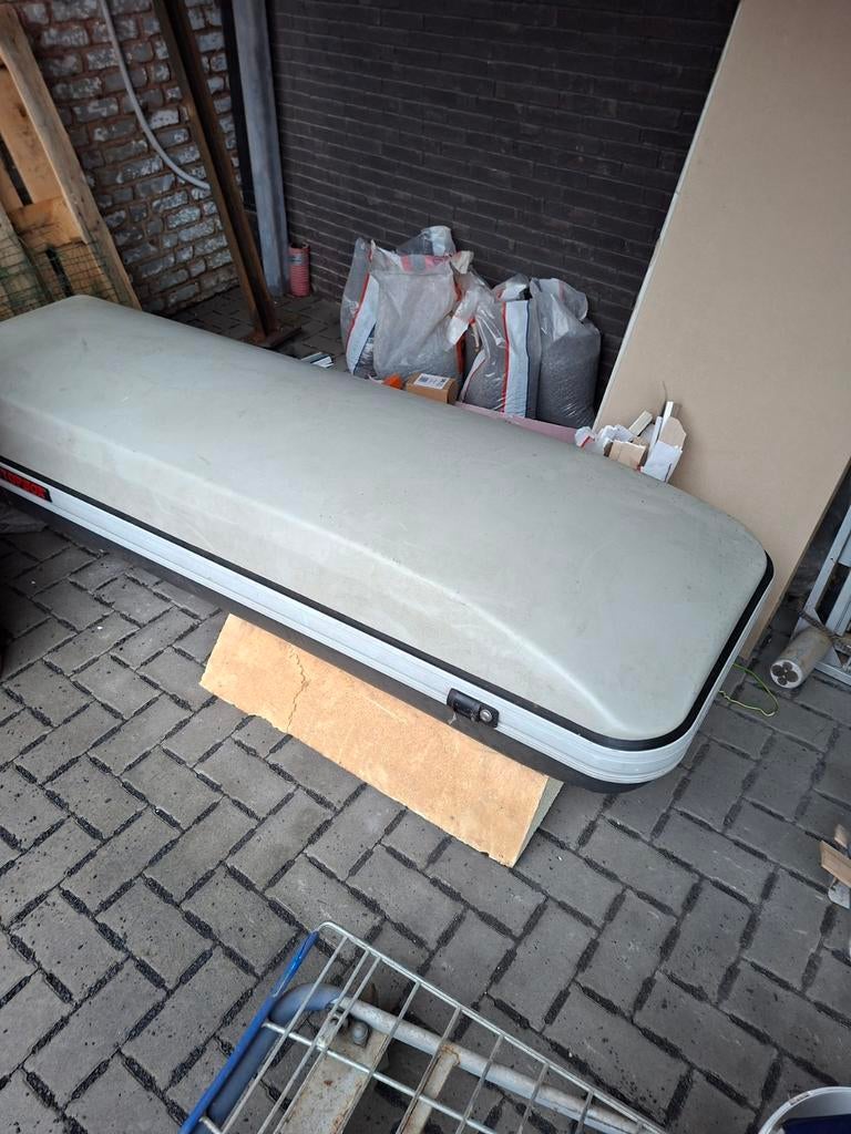 Reiskoffer voor auto skibox, Ophalen