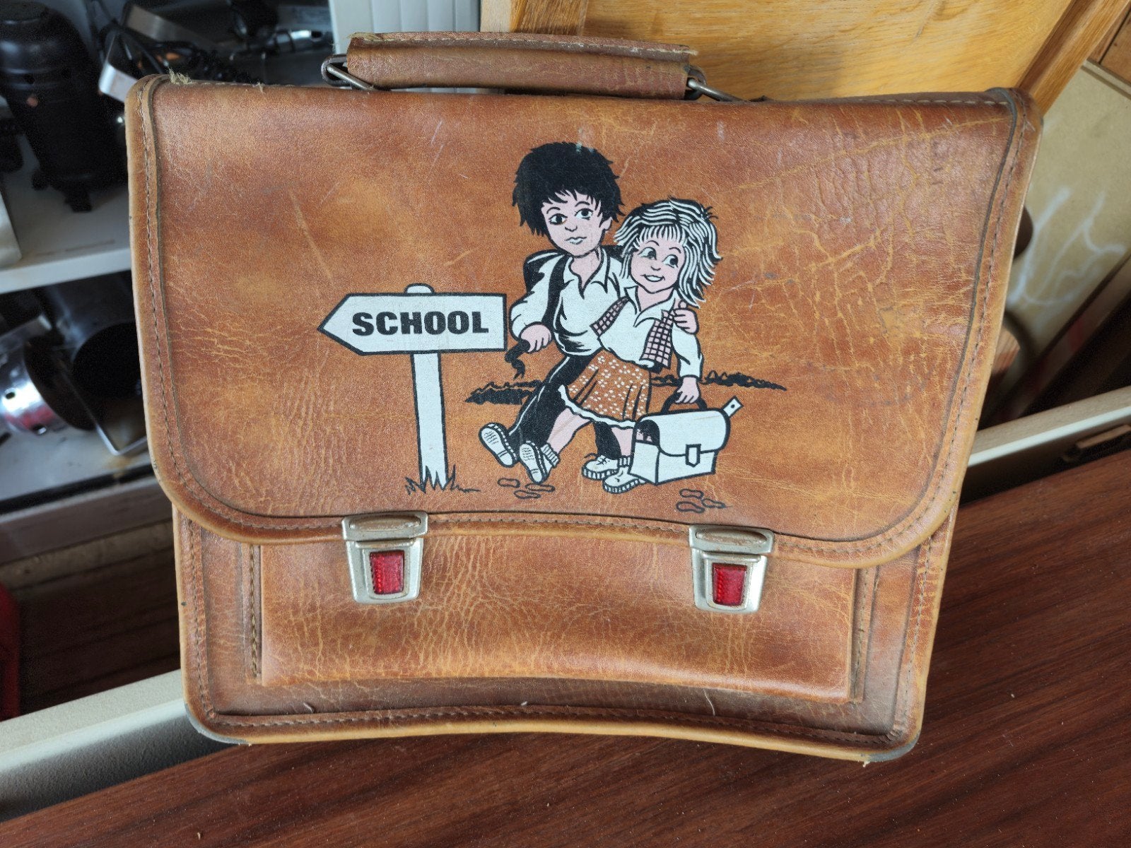 oud schoolboekentasje, Ophalen