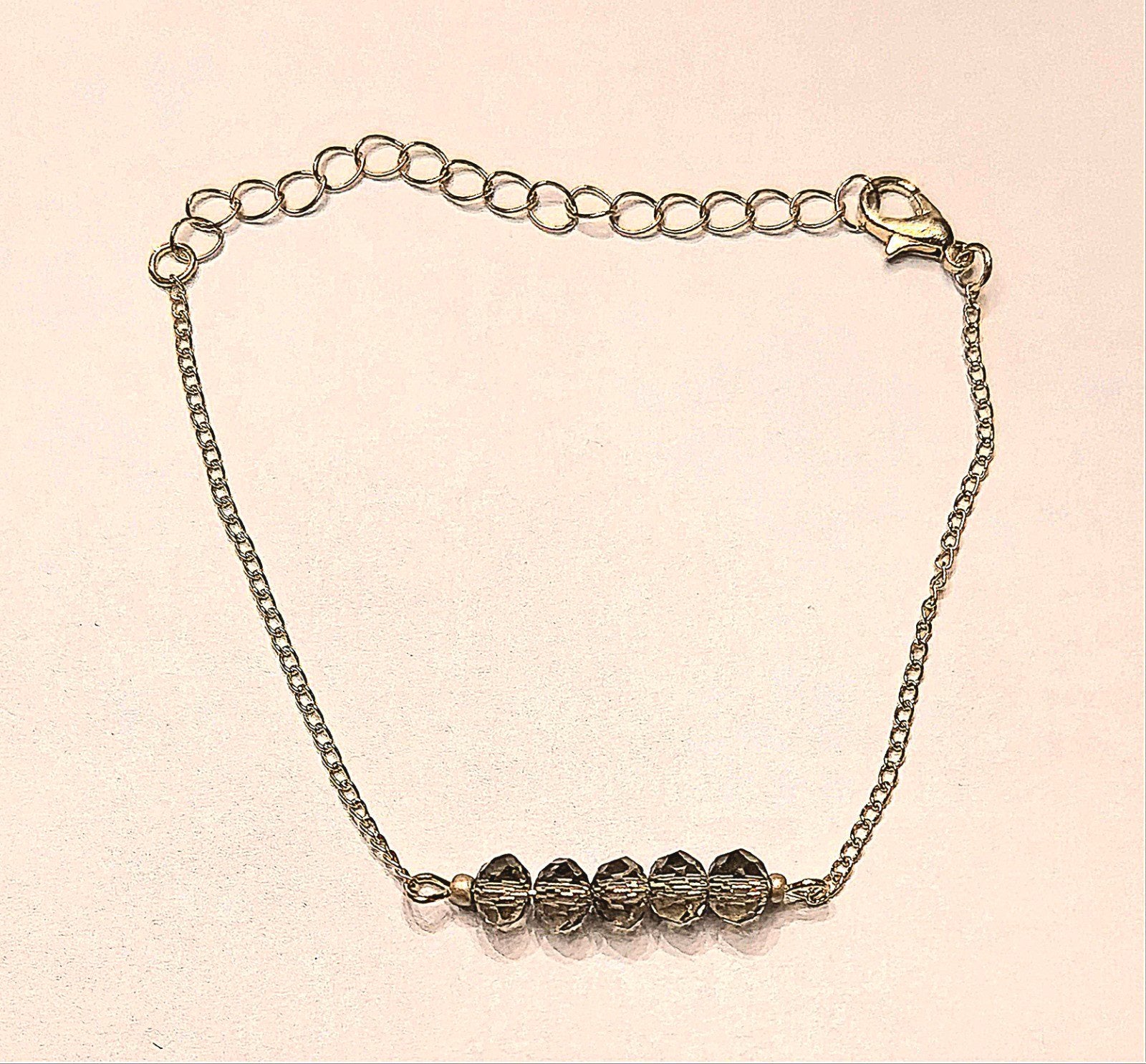 Ongedragen Gouden Schakelarmband met 5 donkere kralen, Nieuw, Ophalen of Verzenden, Met bedels of kralen, Goud