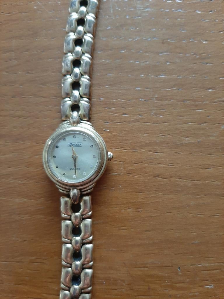 Rodania dameshorloge Quartz goudkleurig
bandje, Handtassen en Accessoires, Overige Accessoires, Gebruikt, Ophalen of Verzenden