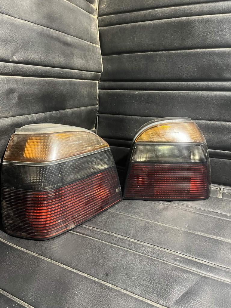 Volkswagen Golf 3 Smoked Hella OEM tail lights, Auto-onderdelen, Ophalen of Verzenden, Volkswagen