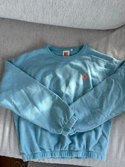 AO76 lichtblauwe trui met oranje accent  12jaar   NIEUW, Neuf, Enlèvement ou Envoi, Pull ou Veste, AO76 American Outfitters