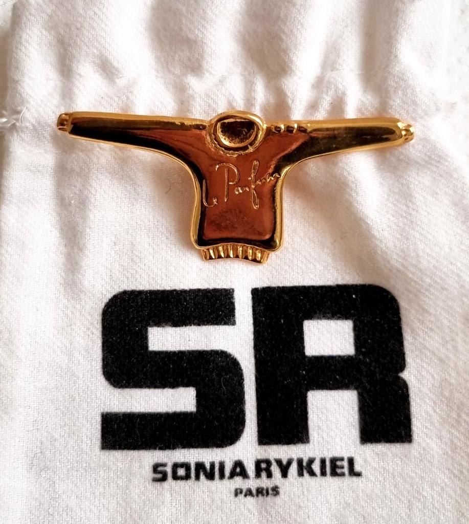 Pin's/broche parfum signé Sonia Rykiel dans son pochon, Envoi, Neuf, Insigne ou Pin's