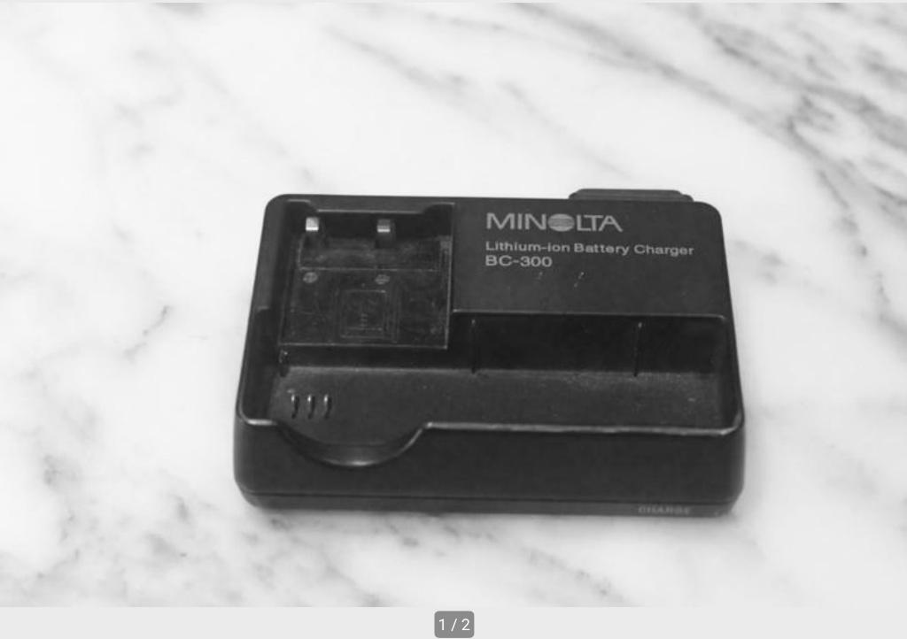 Minolta BC-300 batterijlader., Audio, Tv en Foto, Ophalen of Verzenden, Gebruikt