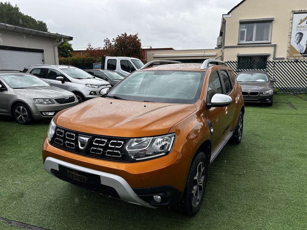 Dacia Duster 1.3 TCe 4X4 Prestige CARPLAY  CAMERA GPS, Auto's, 1849 kg, Stof, Gebruikt, 4 cilinders
