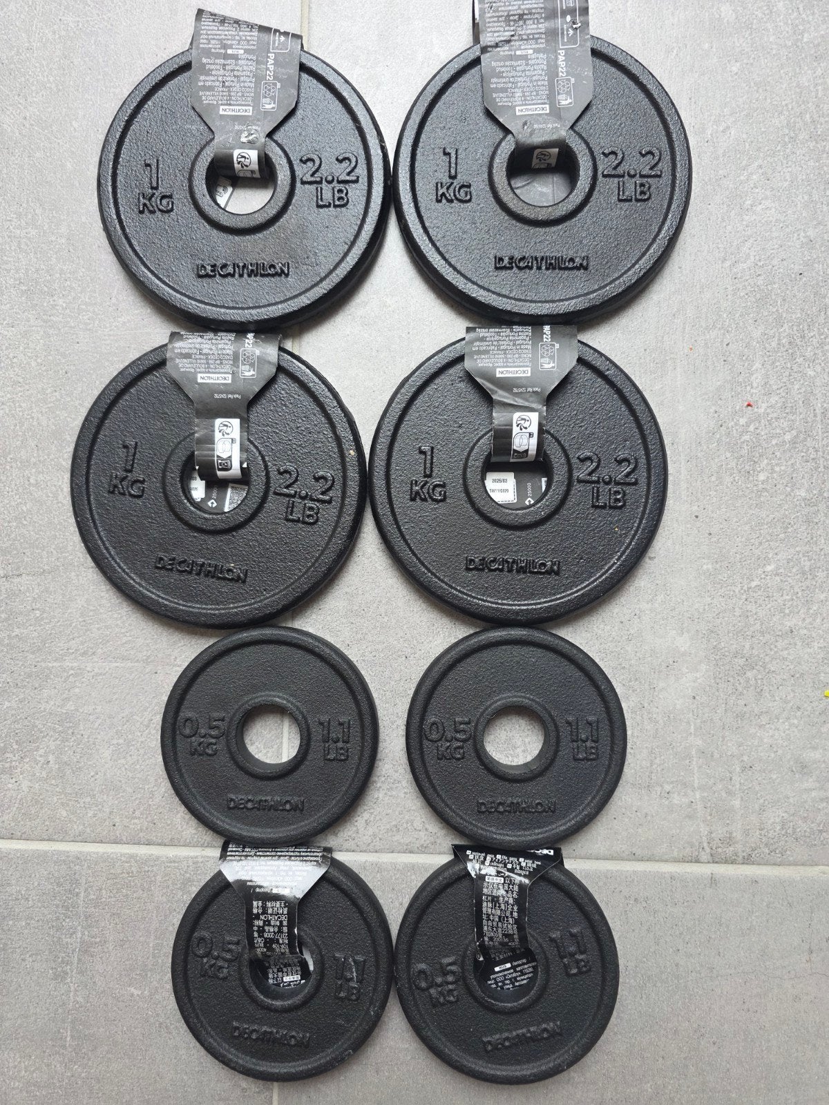 NINE — 8 Decathlon halterschijven 0,5 kg + 1 kg, Ophalen of Verzenden, Nieuw, Benen, Halterschijven