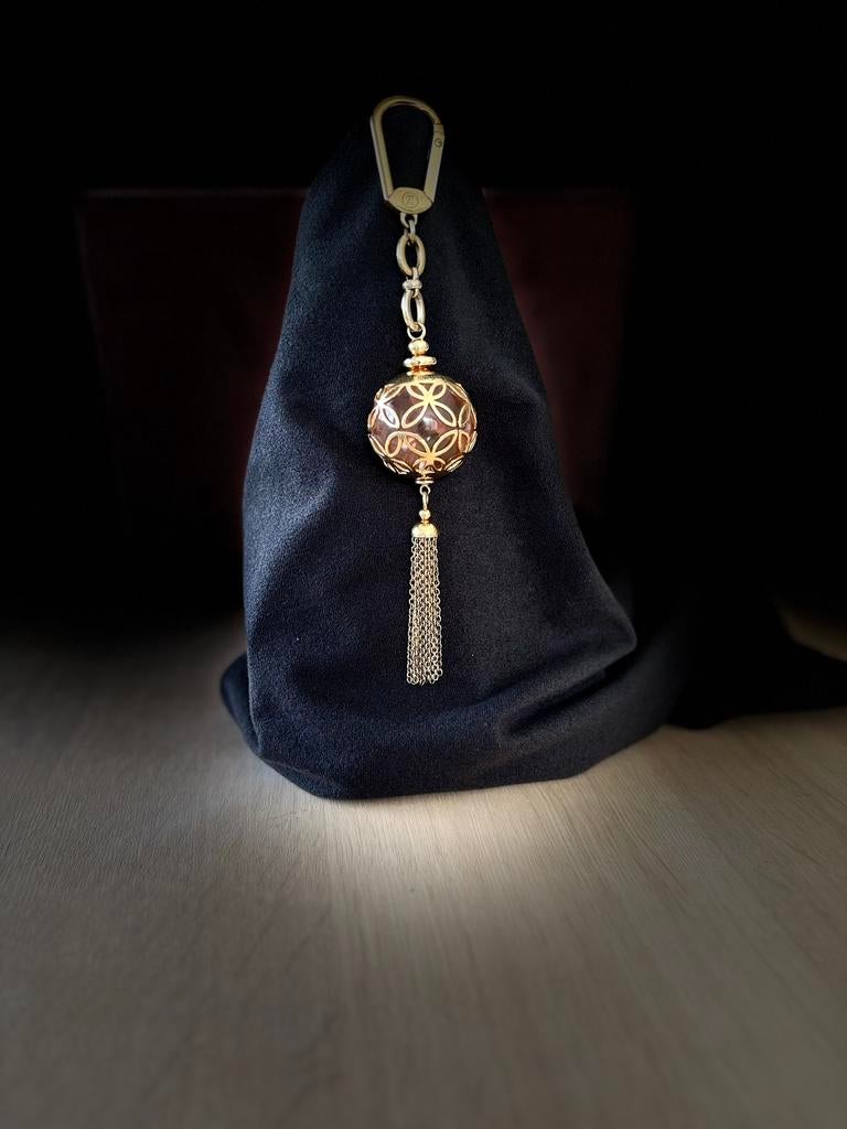 Breloque Louis Vuitton Porte-Clés Swing à pompon doré, Enlèvement