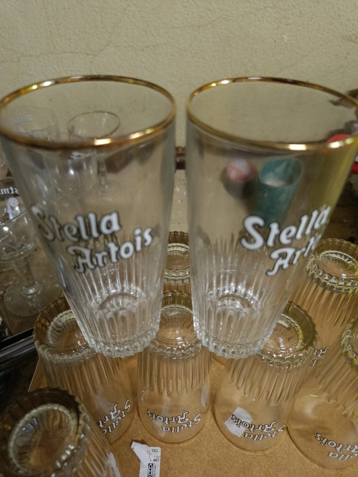 Set van 11 vintage Stella glazen met gouden rand, Ophalen, Zo goed als nieuw, Bierglas