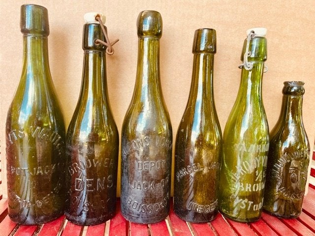 Te koop: oude flessen brouwerijen Heist-op-den-Berg, Ophalen, Gebruikt, Flesje(s), Overige merken