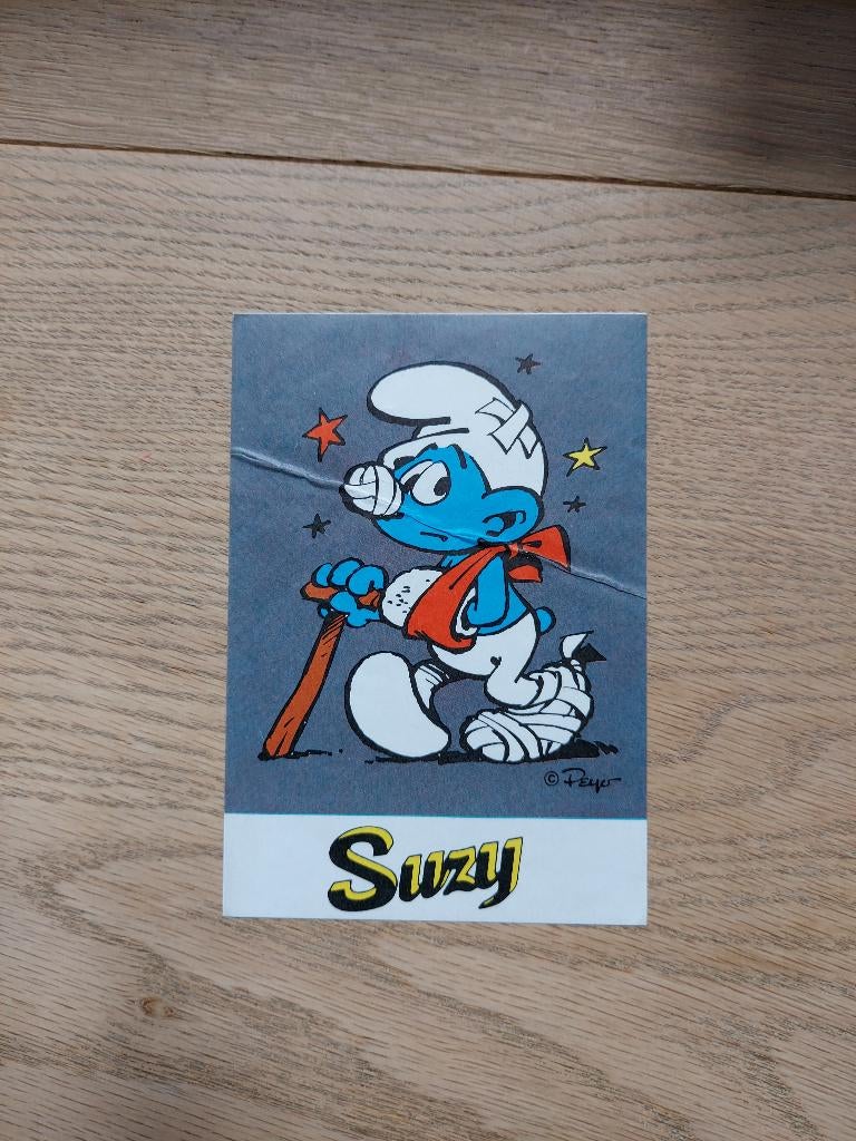 Peyo Smurfen Suzy - Sticker Gebroken been (1976), Enlèvement ou Envoi, Schtroumpfs, Utilisé, Image, Affiche ou Autocollant
