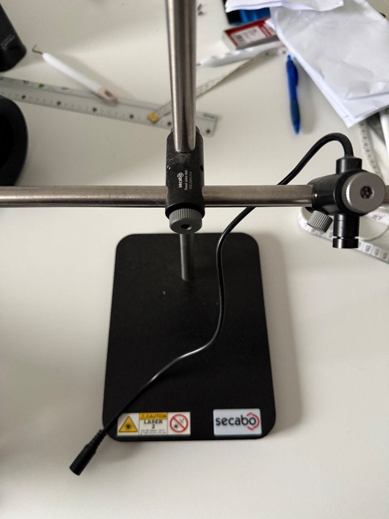 Secabo-positioneringslaser voor het persen van textiel, Ophalen