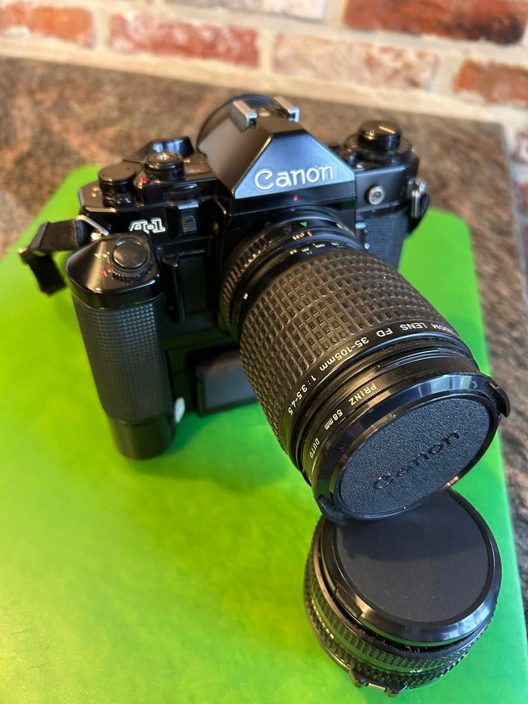 Canon A1 + 50mm + 35-105mm + motordrive, Ophalen, Zo goed als nieuw, Canon