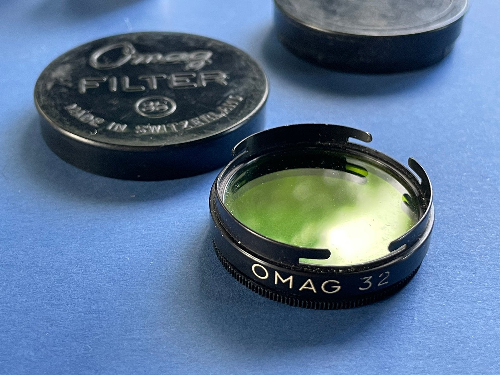 Vintage Omega OMAG 32 camerafilter – Made in Switzerland, Ophalen of Verzenden, Zo goed als nieuw