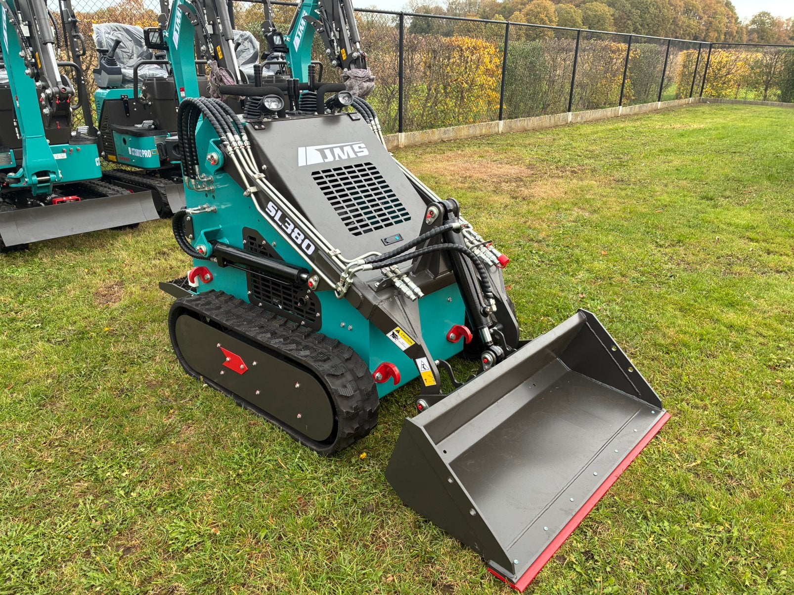 Rups skidsteer met bak en palletvork, Ophalen