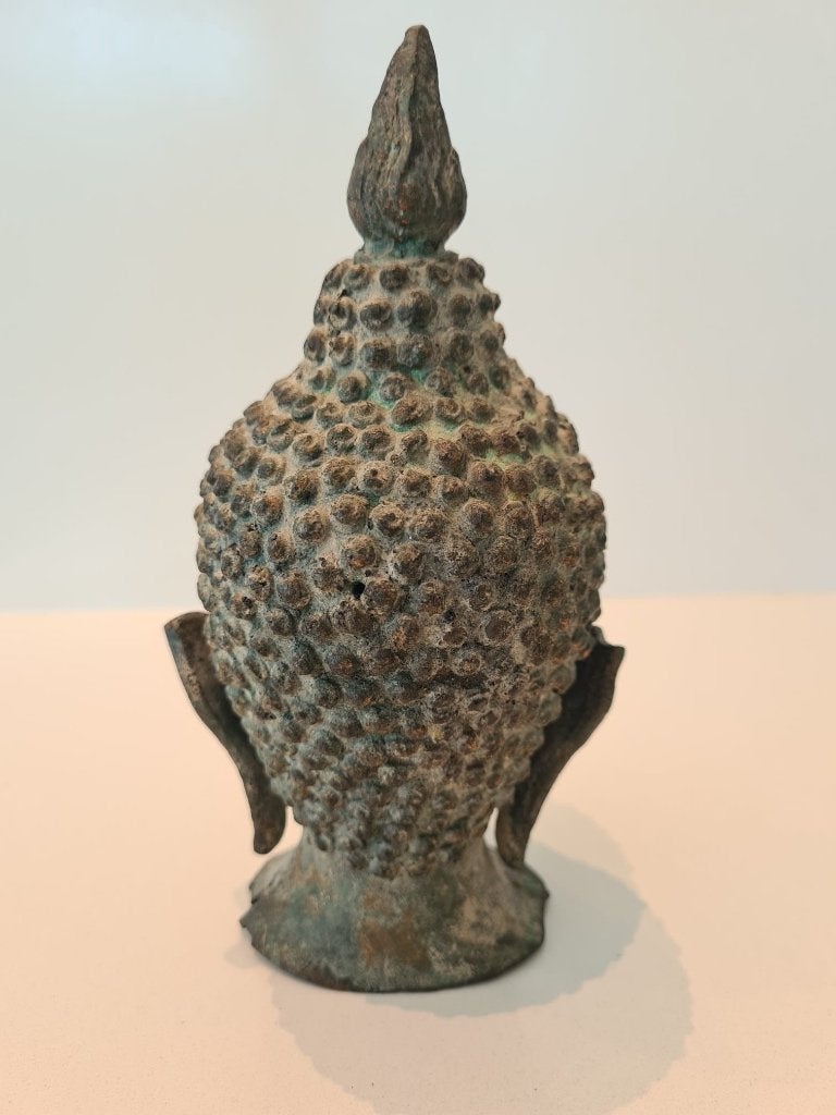 Bronzen boeddha hoofd, Ophalen