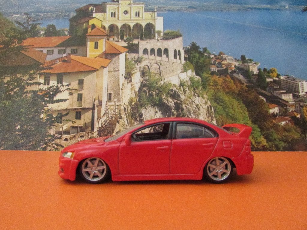 MITSUBISHI LANCER EVOLUTION, Bburago, Ophalen of Verzenden, Zo goed als nieuw, Auto, Overige merken