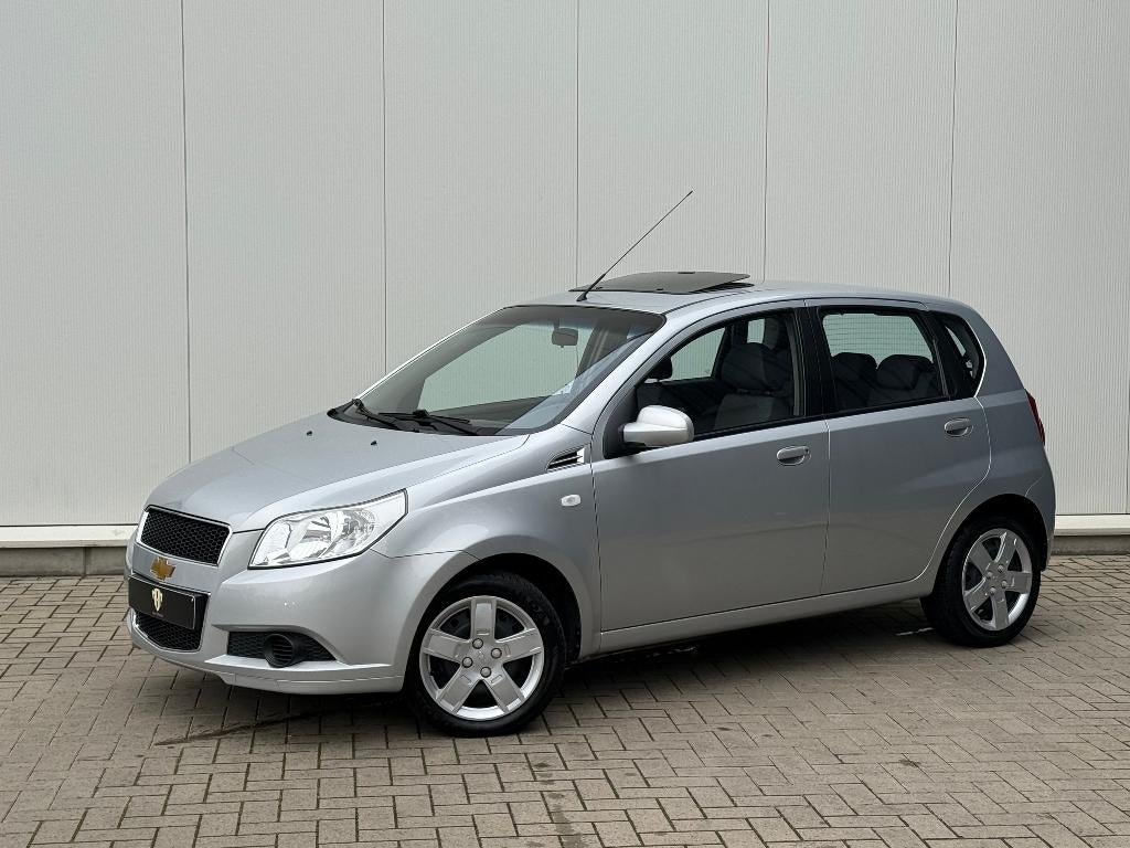 ✅Chevrolet Aveo 1.2 i GARANTIE Airco Trekhaak Open Dak 1.Eig, Auto's, Chevrolet, Voorwielaandrijving, 1206 cc, Stof, 4 cilinders