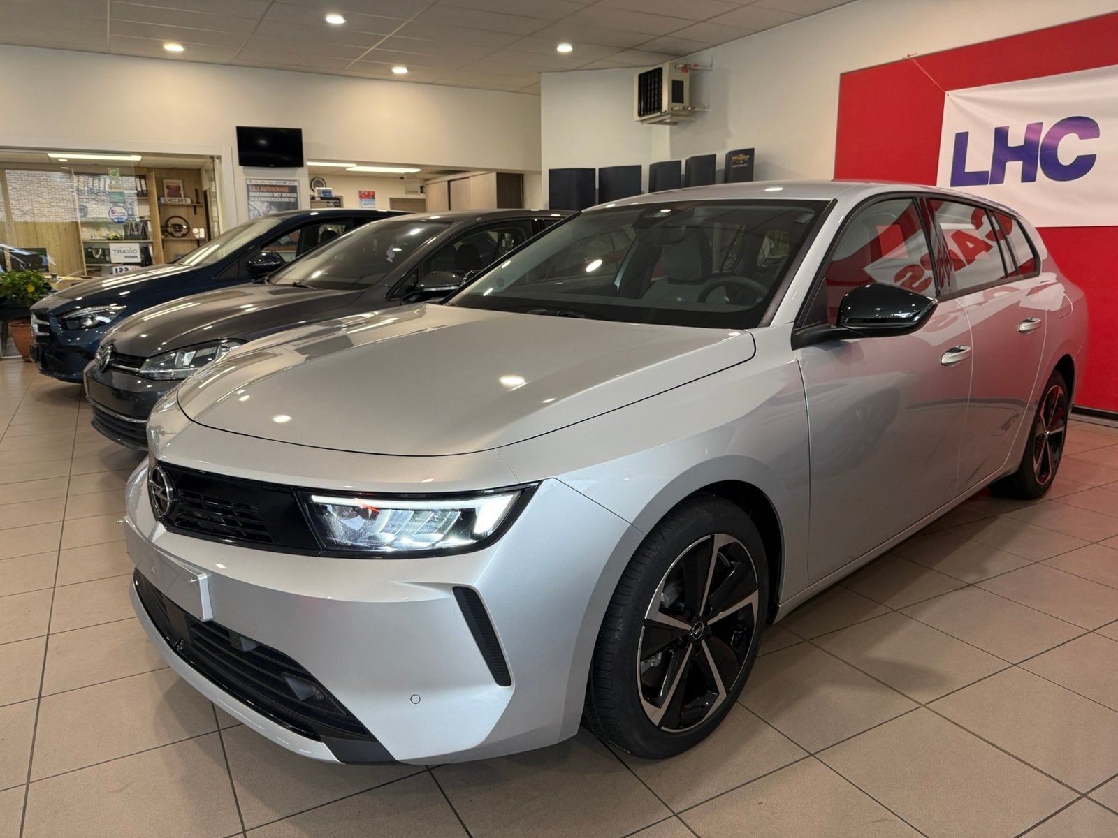 Opel Astra Sports Tourer 1.6i Edition Hybride Automaat 23klm, Autos, Argent ou Gris, Achat, Euro 6, Entreprise