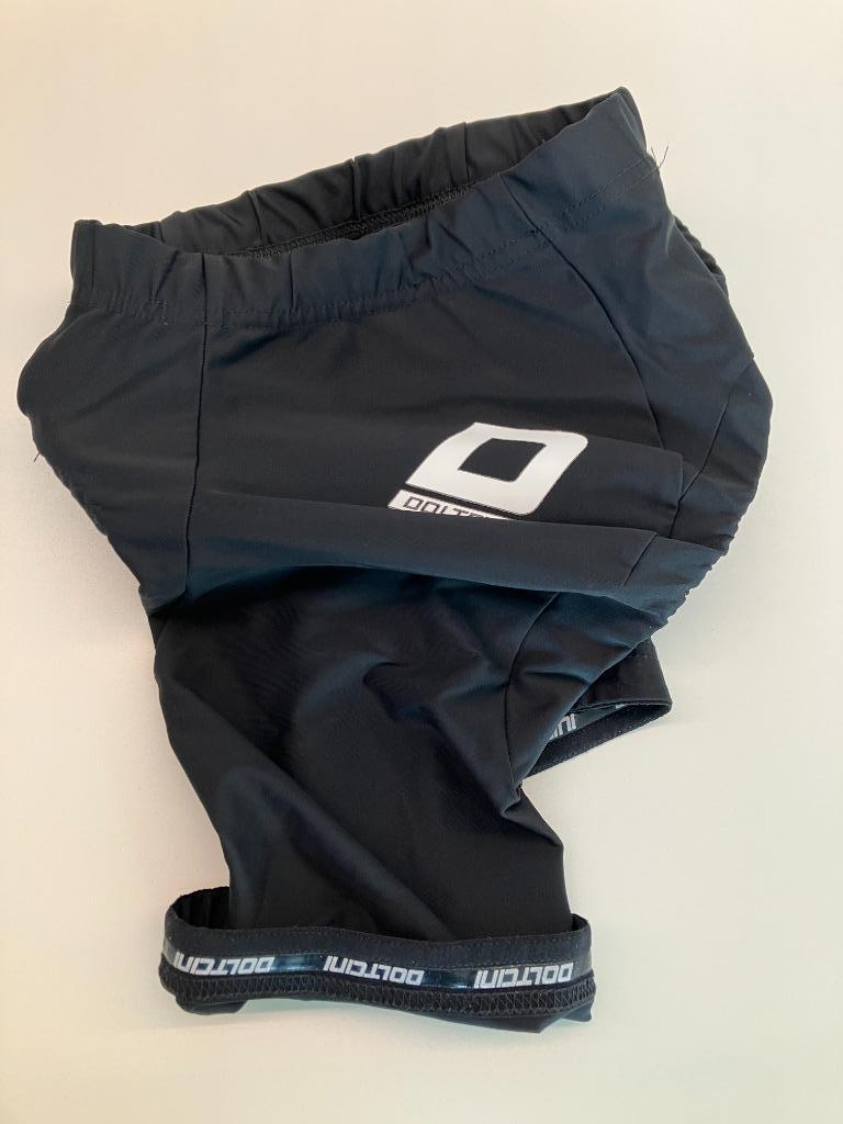 Zwarte koersbroek doltcini kinderen +/- 12 jaar (zo goed als, Vêtements d'extérieur, Enlèvement ou Envoi, Comme neuf, Doltcini