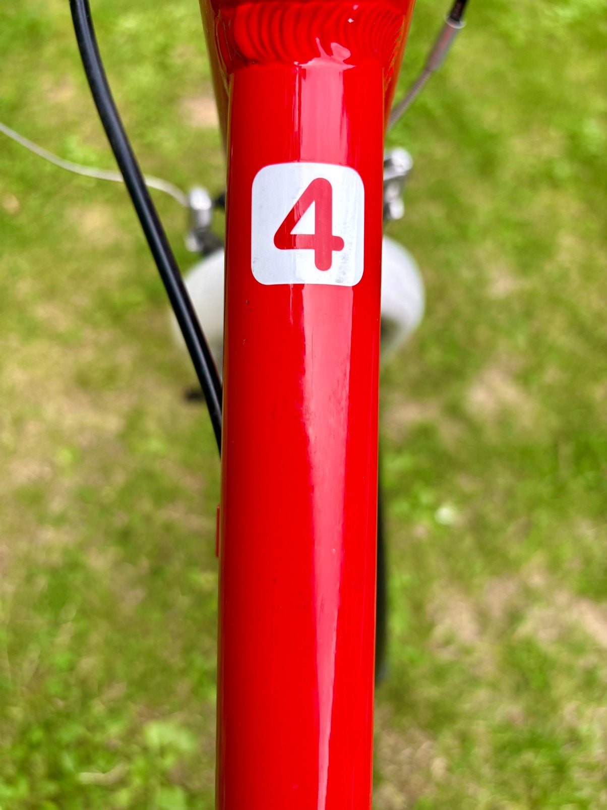 Kinderfiets - Woom 4 - Rood (nieuwprijs: EUR 602,90), Ophalen, Zo goed als nieuw, Velgrem, 20 inch of meer