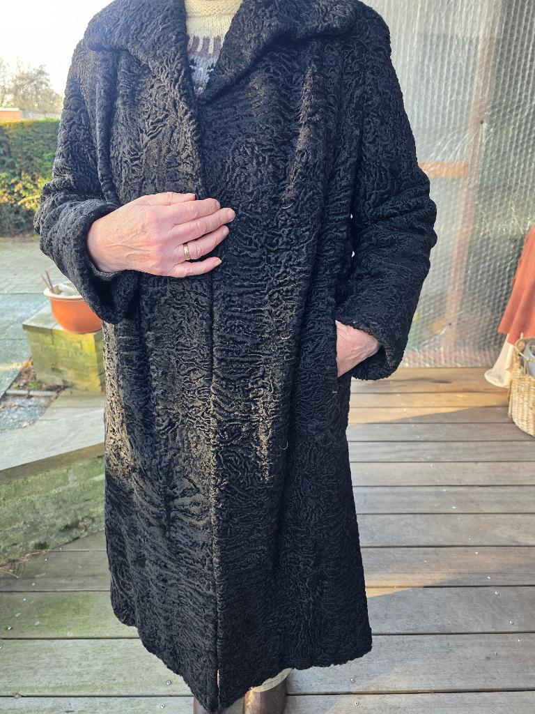 Astrakan Bontmantel lang zwart, M44, Kleding | Dames, Jassen | Winter, Zo goed als nieuw, Maat 42/44 (L), Zwart, Ophalen of Verzenden