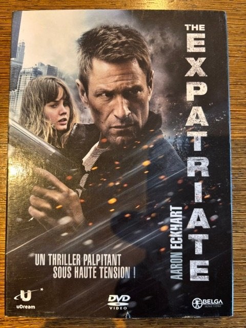 The Expatriate (Aaron Eckhart, Olga Kurylenko), À partir de 6 ans, Comme neuf, Thriller d'action, Enlèvement