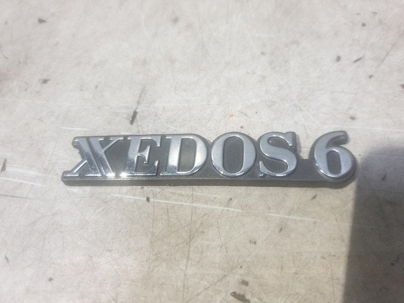 LOGO / EMBLEME Mazda Xedos 6 (01-1992/01-1999), Hitdorfer Straße 73
51371  Leverkusen, DE, Mazda, Utilisé, Info@mazda.de