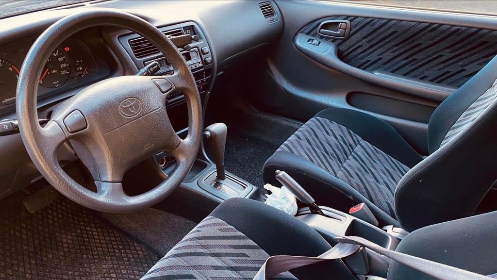 Toyota Corolla automaat NL papieren, Auto's, Toyota, Stof, Zwart, 4 cilinders, Blauw