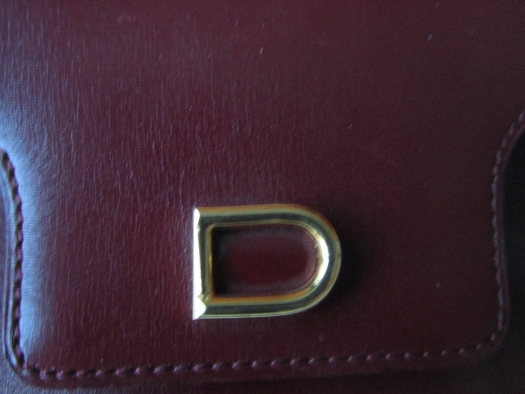 DELVAUX Portemonnaie  bordeaux siglé, Envoi