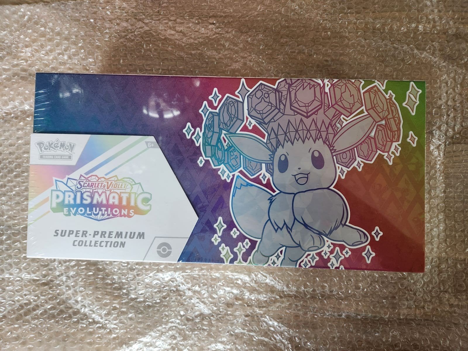 Boîte de collection Pokémon Prismatic Evolutions Super-Premi, Enlèvement ou Envoi, Neuf, Booster