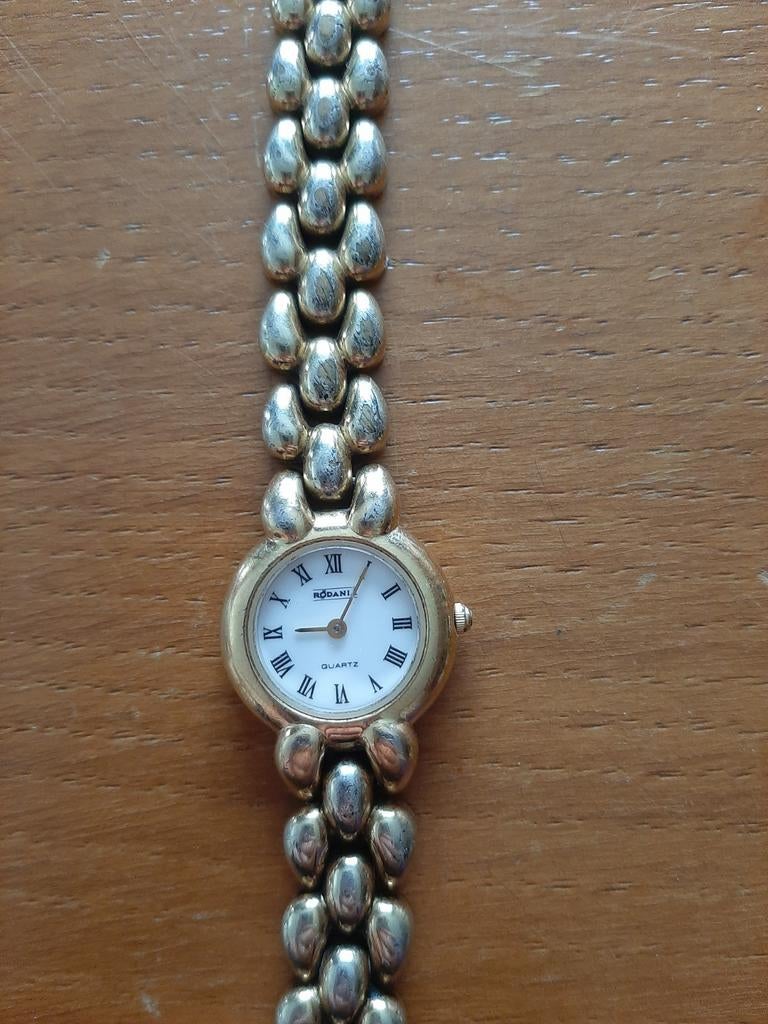 Montre à quartz en métal doré Rodania pour femme avec bracel, Bijoux, Sacs & Beauté, Accessoires Autre, Enlèvement ou Envoi, Utilisé