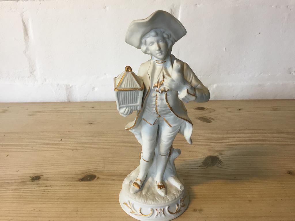 Porcelein beeldje man met kooi en vogel 20 cm