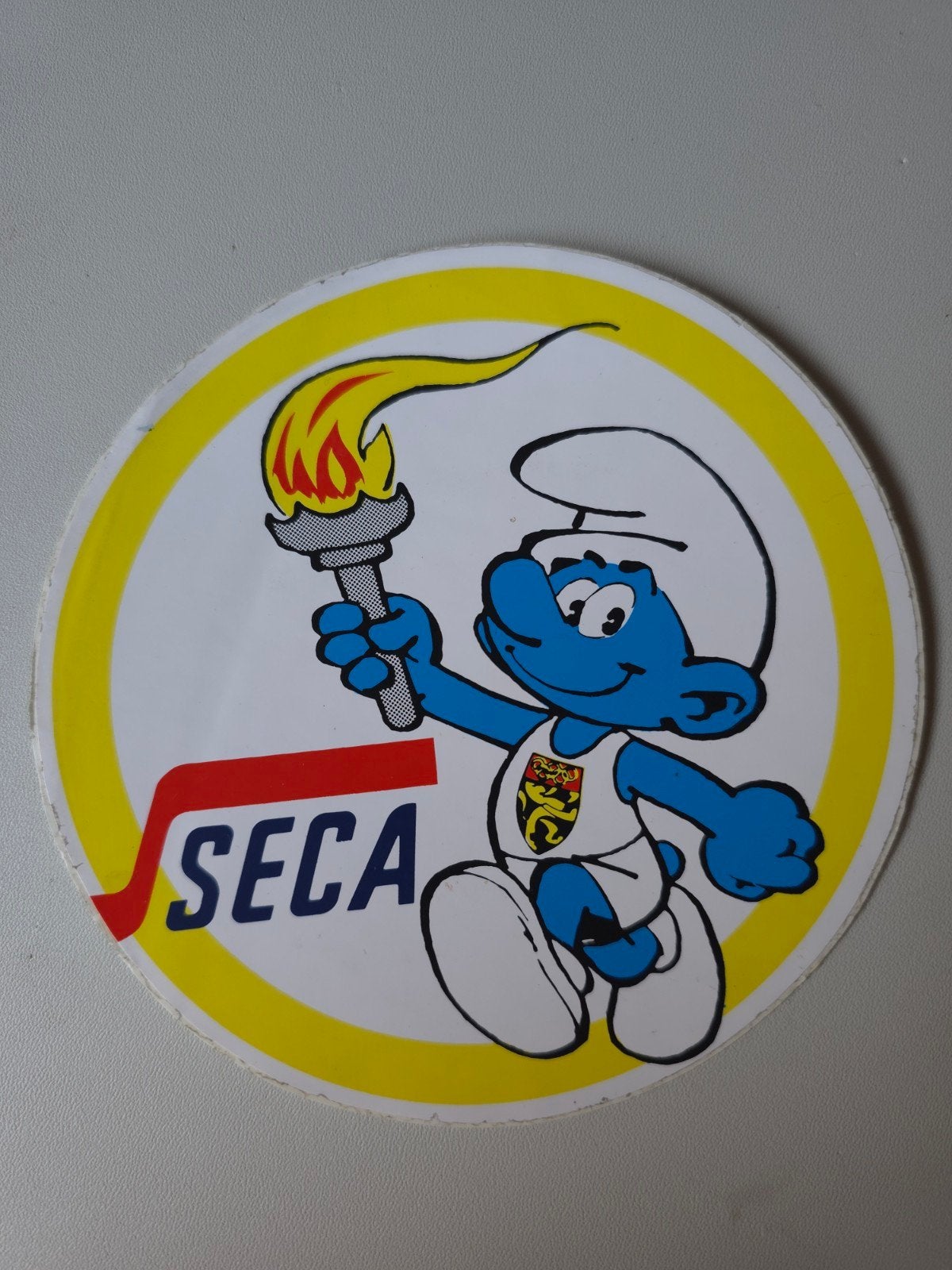 Autocollant Schtroumpf Olympique Seca, Verzamelen, Smurfen, Zo goed als nieuw, Overige typen, Overige Smurfen, Verzenden