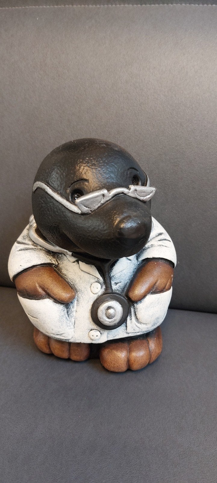 ludiek beeldje arts, Ophalen