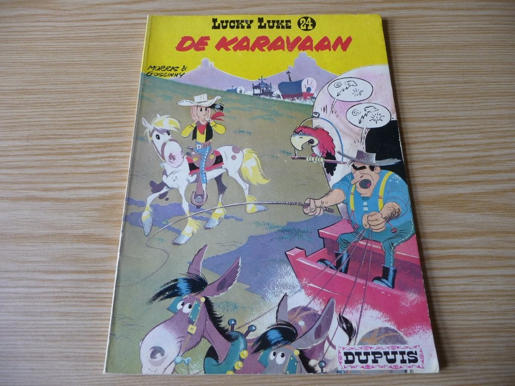 Lucky Luke24. De karavaan 1977 €2, Eén stripboek, Ophalen of Verzenden, Zo goed als nieuw, Morris & Goscinny,