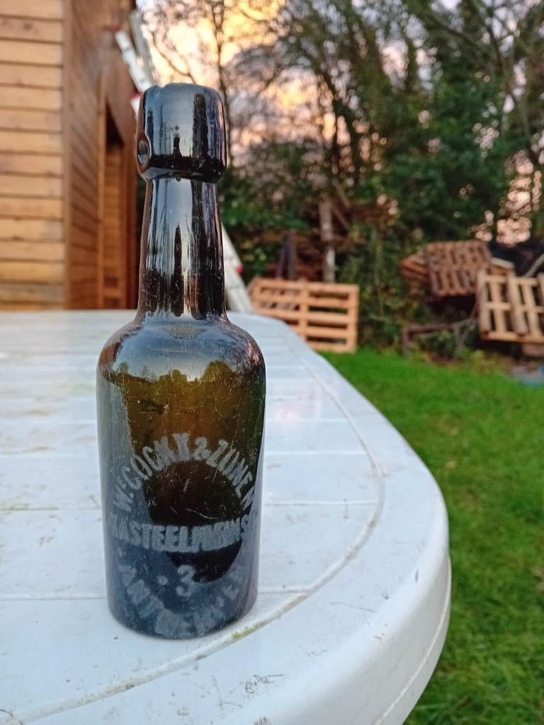Oude vintage bierfles  we. Cocky en zonen Antwerpen Anvers, Verzamelen, Biermerken, Ophalen of Verzenden, Gebruikt