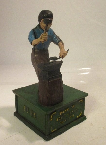 vintage gietijzeren mechanische spaarpot met een smid, Envoi