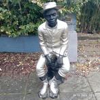 bronzen beeld zittende man, Ophalen, Brons