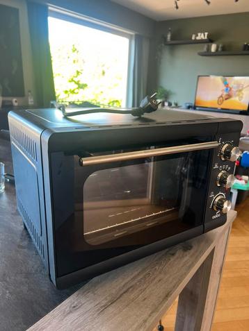 Kleine oven met draaispit Quigg beschikbaar voor biedingen