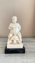 Beeldje man op schild pad, Ophalen