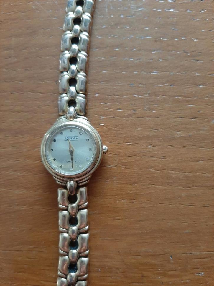 Rodania dameshorloge Quartz goudkleurig
bandje, Handtassen en Accessoires, Overige Accessoires, Gebruikt, Ophalen of Verzenden